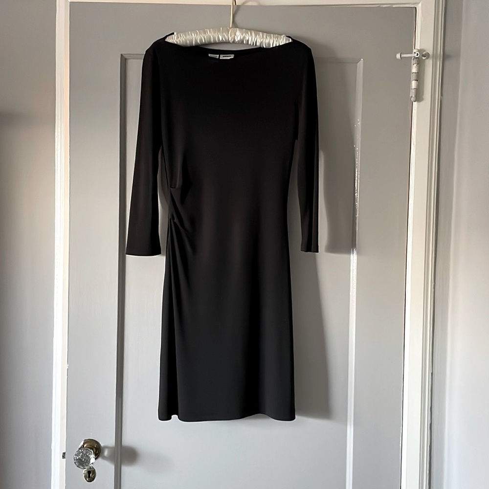 Black cocktail dress with gathered pleat waist detail.